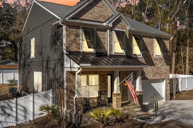 view of front of home featuring a garage and a porch