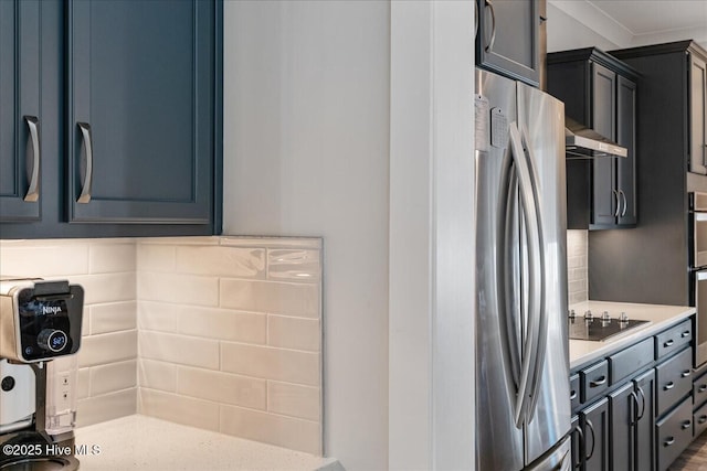 kitchen with crown molding, stainless steel appliances, wall chimney range hood, and backsplash