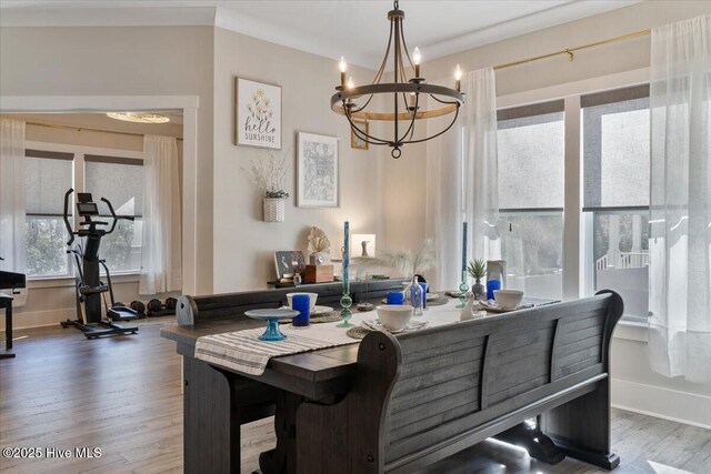 dining space with an inviting chandelier and hardwood / wood-style flooring