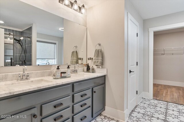 bathroom featuring vanity and tiled shower