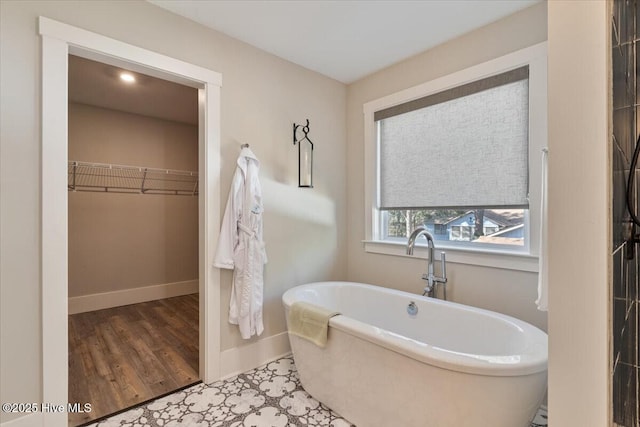 bathroom featuring wood-type flooring and a bathtub