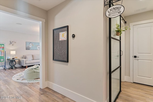 corridor with light hardwood / wood-style flooring