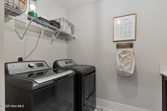 laundry room featuring washing machine and clothes dryer