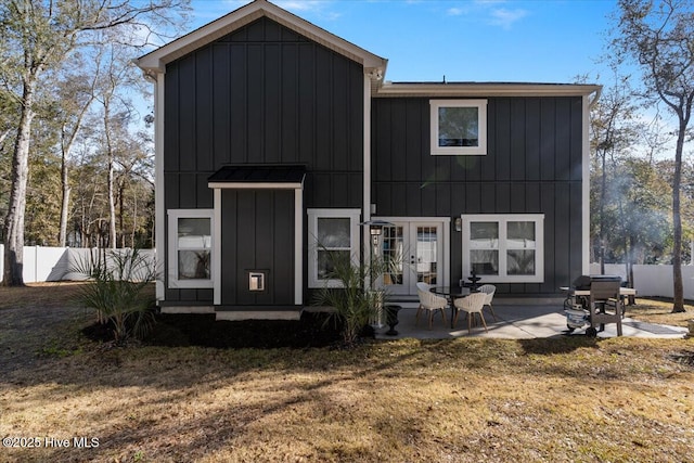 back of house with a patio, a yard, and french doors