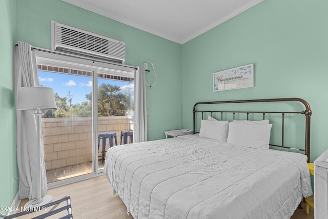 bedroom featuring crown molding, wood finished floors, and access to exterior