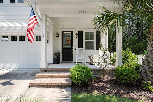 entrance to property featuring a garage and a porch