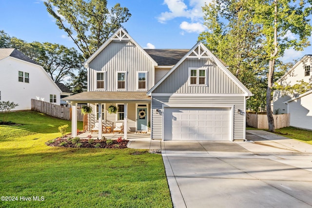 view of front of home featuring a garage, a porch, and a front yard