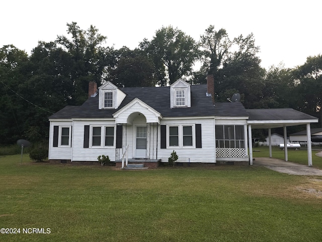 cape cod house featuring crawl space, a chimney, a front lawn, and an attached carport