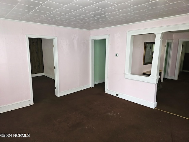 unfurnished room featuring concrete floors and baseboards