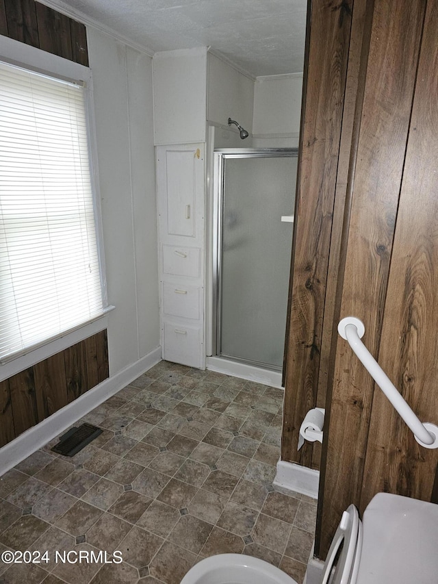 full bath with ornamental molding, a stall shower, and visible vents