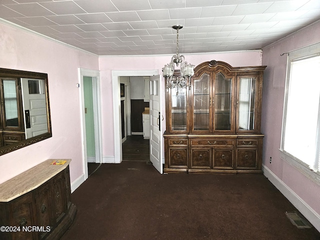 unfurnished dining area with a chandelier, visible vents, plenty of natural light, and baseboards