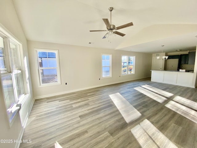 unfurnished living room featuring vaulted ceiling and hardwood / wood-style flooring