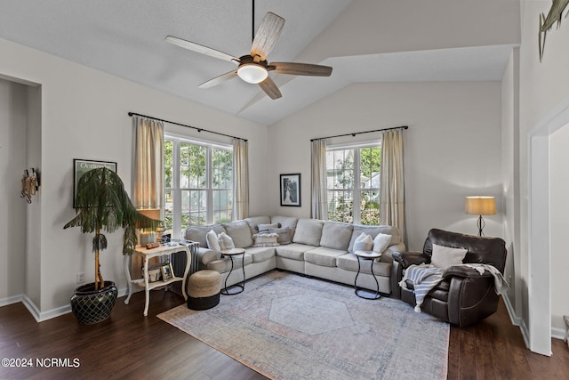 living room featuring ceiling fan, a healthy amount of sunlight, lofted ceiling, and dark wood-type flooring