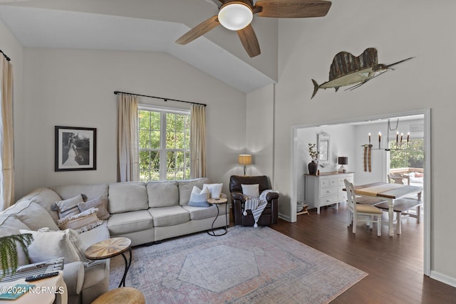 living room featuring ceiling fan with notable chandelier, lofted ceiling, and dark wood-type flooring