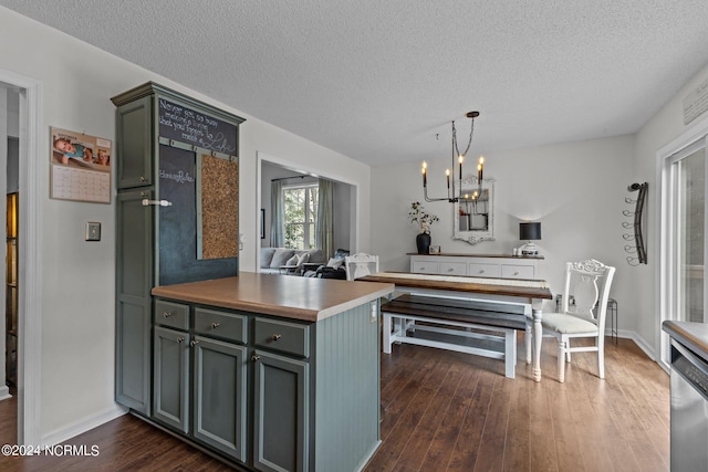 kitchen with dishwasher, dark hardwood / wood-style floors, kitchen peninsula, a chandelier, and a textured ceiling