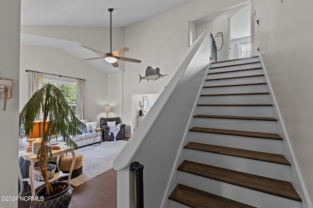 stairs featuring hardwood / wood-style flooring, ceiling fan, and vaulted ceiling