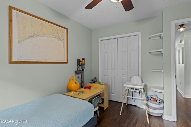 bedroom featuring a textured ceiling, a closet, ceiling fan, and dark hardwood / wood-style floors