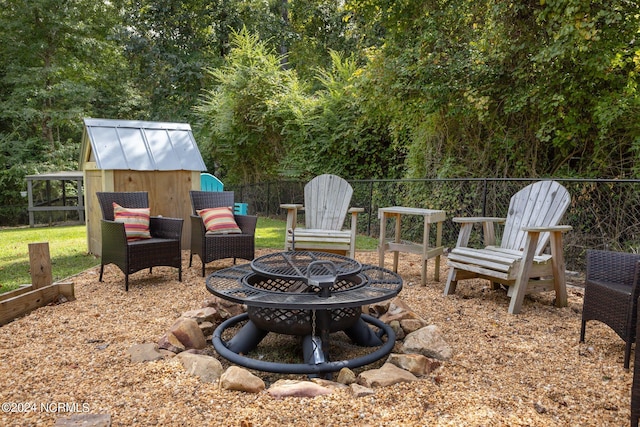 view of patio with an outdoor structure and an outdoor fire pit