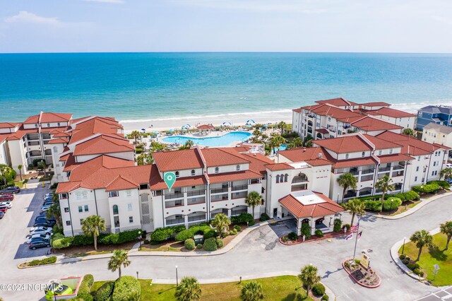 aerial view with a water view and a beach view