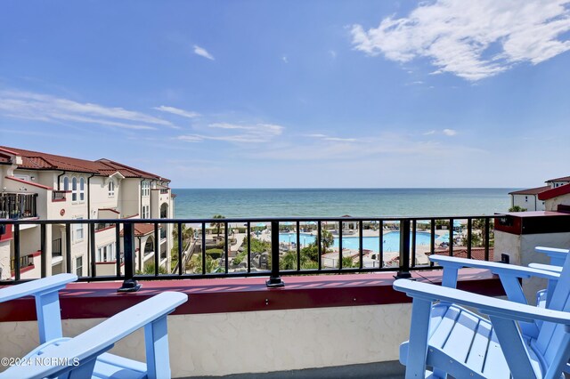 balcony with a view of the beach and a water view