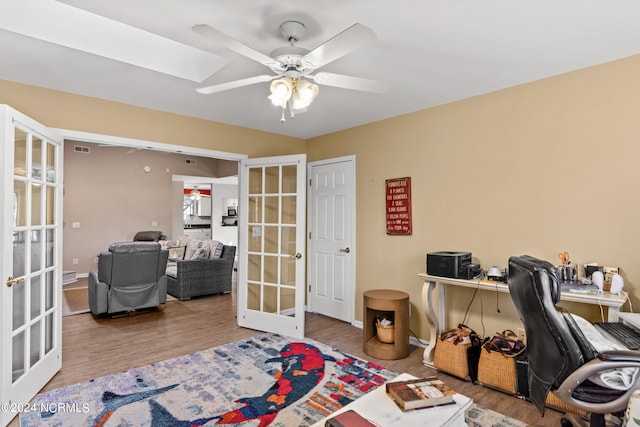 office area featuring ceiling fan, wood finished floors, visible vents, baseboards, and french doors