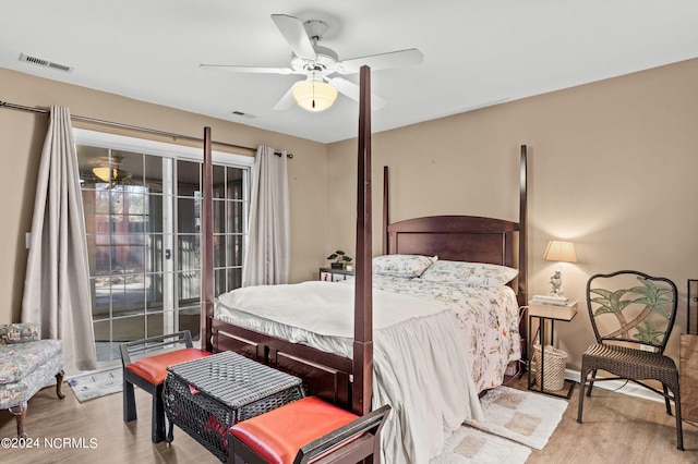 bedroom featuring access to outside, visible vents, ceiling fan, and wood finished floors