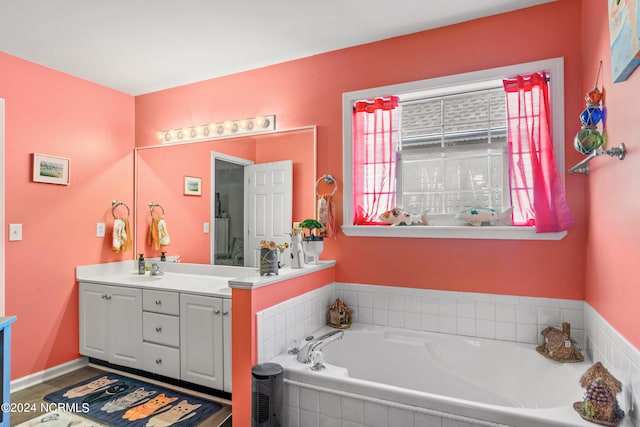 bathroom featuring vanity and a bath