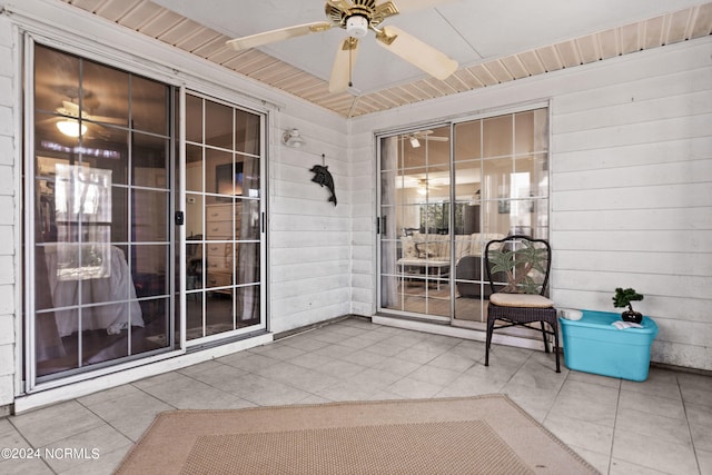 unfurnished sunroom with a ceiling fan