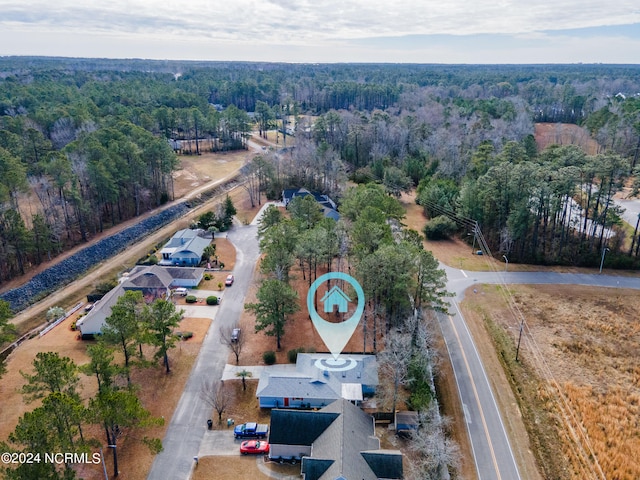 birds eye view of property with a view of trees