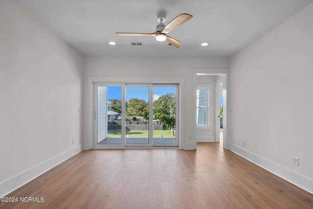 empty room with ceiling fan and light wood-type flooring