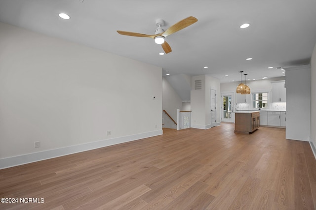 unfurnished living room featuring light wood-style floors, recessed lighting, visible vents, and baseboards