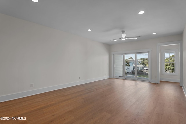 spare room featuring recessed lighting, visible vents, ceiling fan, wood finished floors, and baseboards