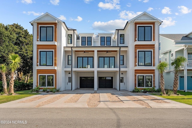 townhome / multi-family property with driveway, a balcony, and an attached garage