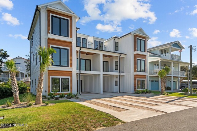 view of front of property with a balcony and a front lawn