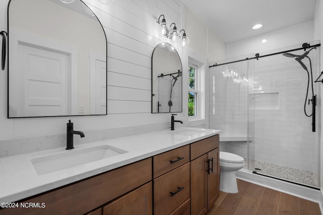 full bathroom featuring toilet, a shower stall, and a sink