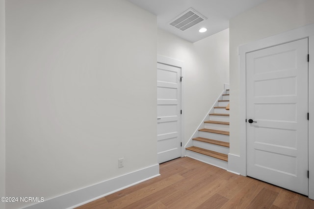 interior space featuring stairs, wood finished floors, visible vents, and baseboards