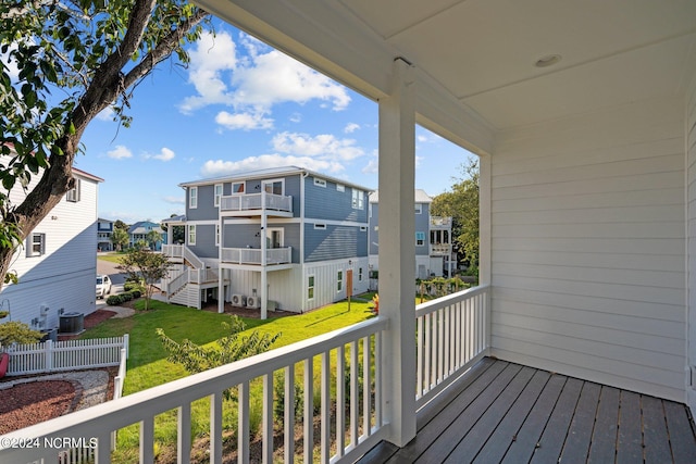 balcony featuring a residential view and cooling unit