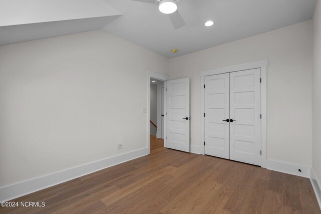 unfurnished bedroom featuring ceiling fan, a closet, and hardwood / wood-style floors