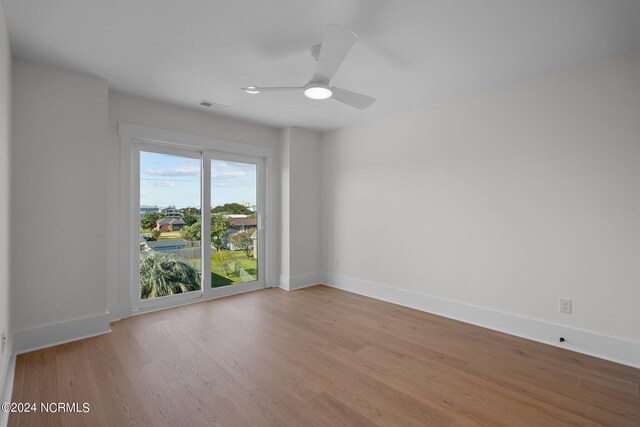 spare room featuring light wood-type flooring and ceiling fan