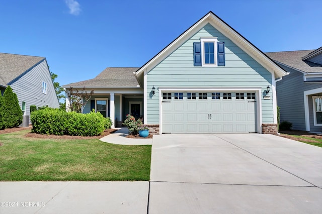 view of front of house featuring a garage and a front lawn