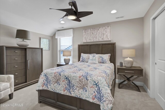 bedroom featuring ceiling fan, light carpet, a closet, and vaulted ceiling