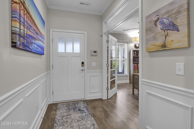 entryway featuring dark wood-type flooring and ornamental molding