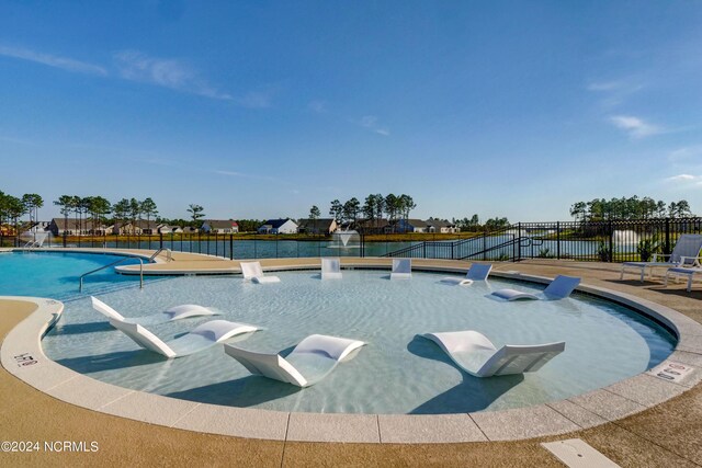 view of swimming pool featuring pool water feature