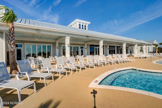 exterior space with a community pool and a patio area