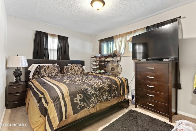 carpeted bedroom with baseboards and a textured ceiling