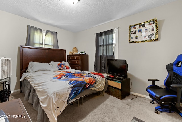 carpeted bedroom with a textured ceiling