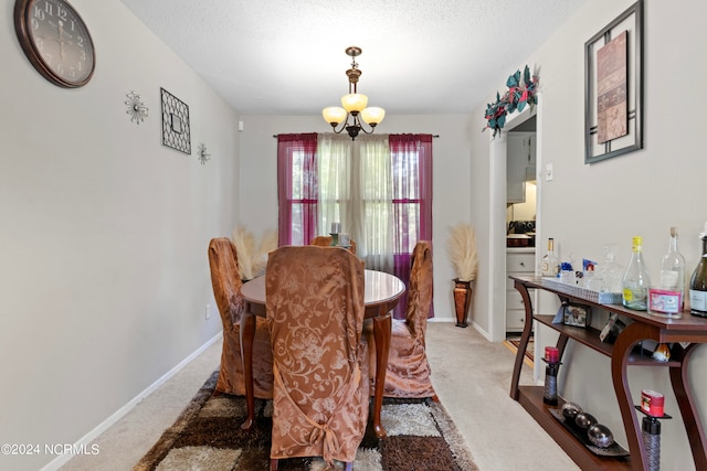 carpeted dining area with a textured ceiling and an inviting chandelier