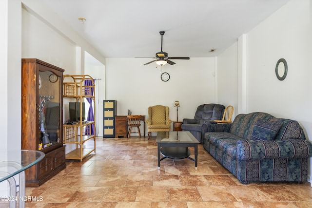 living room with ceiling fan and stone finish floor