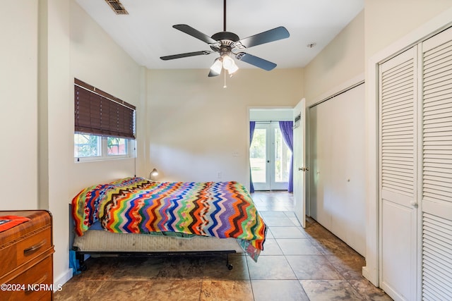 tiled bedroom with ceiling fan and french doors