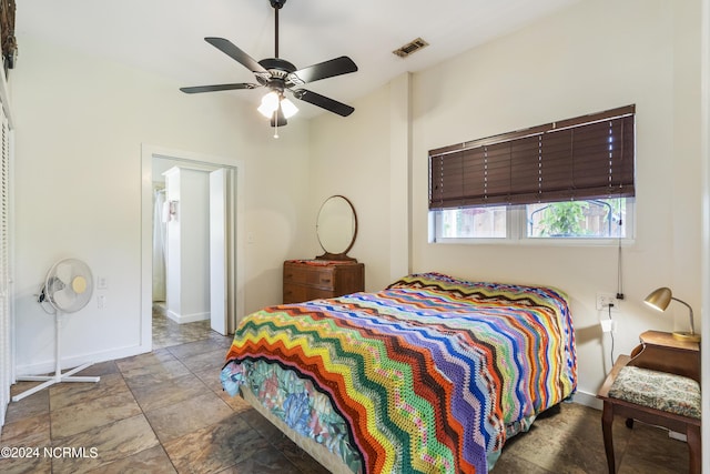 bedroom featuring baseboards, visible vents, and a ceiling fan